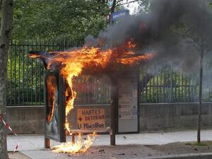 A bus stop was burned during a demonstration on the sidelines of the march for the annual May Day workers' rally, in Paris / AFP