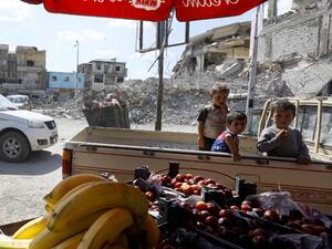 Children ride in the back of a pickup truck at a vegetable market in the Syrian city of Raqa on May 17, 2018, during the holy month of Ramadan. The Syrian Democratic forces (SDF) recently drove the Islamic State (IS) group out of large parts of northern and eastern Syria, including the onetime jihadist capital of Raqa, with help from the coalition's air strikes, weapons and special forces advisors. (DELIL SOULEIMAN / AFP)