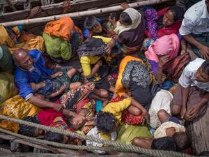 Rohingya refugees arriving by boat at Shah Parir Dwip on the Bangladesh side of the Naf River (AFP)