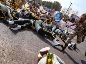 Iranians scramble to the ground during the attack in Ahvaz, Iran (MORTEZA JABERIAN /AFP)
