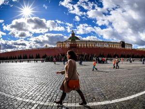 A woman walks on Red Square in front of the Kremlin in downtown Moscow (AFP)