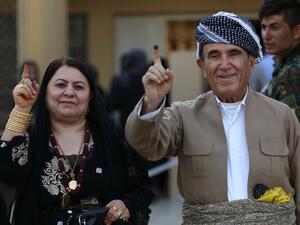 Iraqi Kurds show their ink-stained index finger after casting their ballot for the parliamentary election at a polling station in Arbil, the capital of the Kurdish autonomous region in northern Iraq, on September 30, 2018 (AFP)