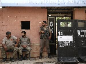 Syrian police stand guard (AFP)