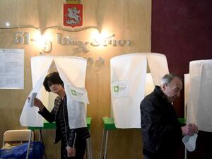 A woman leaves a voting booth at a polling station in Tbilisi on October 28, 2018, during the first round of the Georgian presidential election at a polling station (AFP)