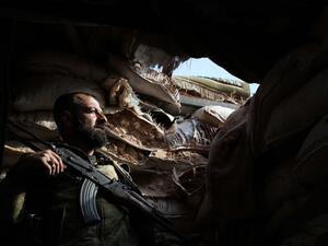 A Syrian rebel-fighter from the National Liberation Front (NLF) takes position on the frontline in the al-Rashedin area west of Aleppo in northwestern Syria. (AFP)
