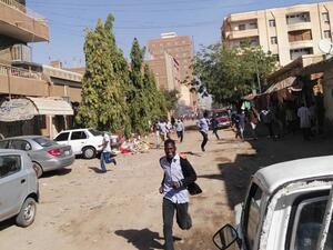 Sudanese protesters run away from tear gas smokes during a demonstration in Khartoum, on December 31, 2018. (AFP)