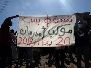 Sudanese demonstrators hold up a banner bearing a slogan calling for the overthrow of the regime during an anti-government protest in Khartoum. (AFP/ File)