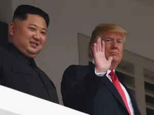 US President Donald Trump (R) waving as he and North Korea's leader Kim Jong Un (AFP)