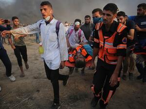 Palestinian paramedics carry a wounded protester during clashes with Israeli forces east of Gaza city, along the Gaza-Israel border in the Gaza Strip. (AFP/File)