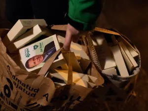 Estonias's Prime Minister Juri Ratas of the centrist Centre party holds a bag full of campaign material as he campaigns (AFP)
