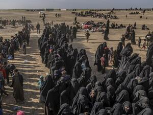 Civilians evacuated from the Islamic State (IS) group's embattled holdout of Baghouz wait at a screening area held by the US-backed Kurdish-led Syrian Democratic Forces (SDF), in Deir Ezzor. (APF)