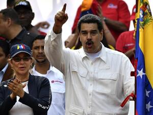 Venezuela's President Nicolas Maduro gestures next to first lady Cilia Flores (L) during a rally at the Miraflores Presidential Palace in Caracas, Venezuela on March 9, 2019. (AFP/ File Photo)