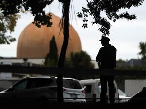 An armed policeman stands guard in front of the Masjid Al Noor Mosque in Christchurch (AFP)