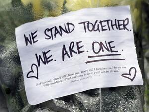 Residents pay their respects by placing flowers for the victims of the mosques attacks in Christchurch at the Masjid Umar mosque in Auckland  (AFP)