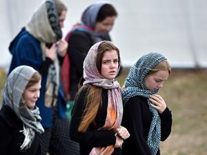 Residents and schoolchildren wearing headscarves arrive for the funeral of those killed in New Zealand's twin mosque attacks at Memorial Park cemetery in Christchurch on March 21, 2019. (AFP/ File)