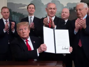 US President Donald Trump holds up a signed Proclamation on the Golan Heights alongside Israeli Prime Minister Benjamin Netanyahu in the Diplomatic Reception Room at the White House in Washington (AFP)