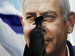 An Ultra Orthodox Jewish man walks past an electoral billboard bearing a portrait of Israel's Prime Minister Benjamin Netanyahu, in Jerusalem, on April 1, 2019. Israeli general elections will be held on April 9, 2019.
THOMAS COEX / AFP 