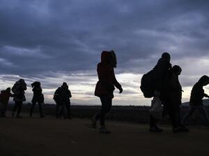 Migrants and refugees walk after crossing the Macedonian border into Serbia on January 10, 2016. More than a million refugees and migrants arrived in Europe in 2015. (AFP/Armend Nimani)