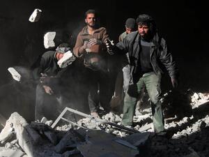 Syrians search for victims amidst the rubble of a destroyed building following airstrikes that hit a kindergarten in the rebel-held region of Eastern Ghouta, near Damascus on January 12, 2016. (AFP/Amer al-Mohibany)