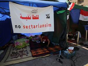 A supporter of Iraqi Shia cleric Moqtada al-Sadr sits inside a tent on the fourth day of a sit-in calling for governmental reform and elimination of corruption on March 22, 2016, outside the main gates of Baghdad's Green Zone. (AFP/Ahmad al-Rubaye)