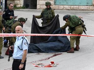 An Israeli soldier was detained after allegedly shooting a wounded Palestinian assailant in the head and killing him as he lay on the ground, with a video of the incident spreading widely online. (AFP/Hazem Bader)