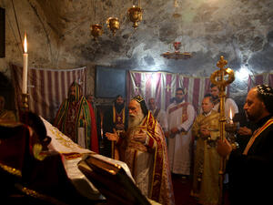 Orthodox priests pray at Jerusalem's Church of the Holy Sepulchre on Sunday (AFP/File Photo)	