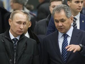 Russian President Vladimir Putin listens to Defence Minister Sergei Shoigu about 450 miles east of Moscow, on February 12, 2016. (AFP/Alexander Zemlianichenko)