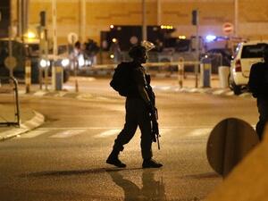 A Israeli soldier walks on the street with weapon at the ready (AFP/File Photo)	