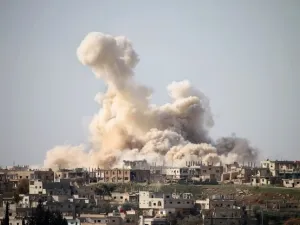 Smoke billows following air strikes in the southern city of Daraa (AFP/File Photo)