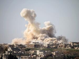 Smoke billows following air strikes in the southern city of Daraa (AFP/File Photo)
