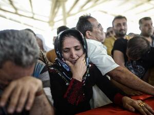 Family members of the victims of the suicide bombing attack in the Turkish city of Suruc gathered for a funeral service on Tuesday, July 21, 2015. (AFP/Bulent Kilic)
