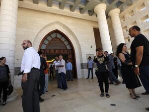 People gather at the presidential palace near the city of Ramallah in the occupied West Bank after Palestinian officials announced a project to transform the building into a national library. President Mahmud Abbas and his cash-strapped administration had faced questions over the construction of the $17.5 million palace, which was initially intended as a presidential headquarters and location where foreign dignitaries could be received. (AFP)