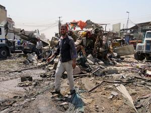 Iraqis look at the damage following a car bomb explosion in Baghdad's Shiite-majority district of Sadr City on August 28, 2017. Security sources said the bombing killed 11 people and wounded another 26. (AFP)