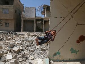 A Syrian boy plays on a swing in a destroyed building in the rebel-held town of Douma, on the eastern outskirts of Damascus, as Muslims celebrate the third day of the Eid al-Adha holiday on September 3, 2017. (AFP)