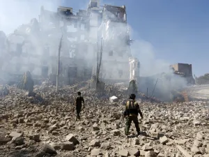 Huthi rebel fighters inspect the damage after a reported air strike carried out by the Saudi-led coalition targeted the presidential palace in the Yemeni capital Sanaa on Dec. 5, 2017 (Mohammed Huwais/AFP)