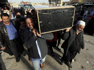 Iraqis carry the coffin of a victim during a funeral in the holy city of Najaf, on January 15, 2018, following today's twin suicide bombing in the capital Baghdad. Iraq's Prime Minister Haider al-Abadi called for the elimination of jihadist "sleeper cells" after the bombing killed 31 people in Baghdad in the second such attack in three days.