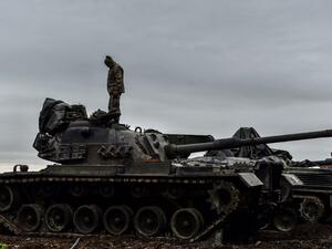A Turkish soldier stands on a tank near the Syrian border at Hassa, in Hatay province on January 24, 2018, as part of the operation "Olive Branch", launched a few days ago. The operation aims to oust the People's Protection Units (YPG) militia, which Turkey considers to be a terror group, from its enclave of Afrin.
(OZAN KOSE / AFP)
