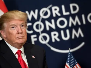 U.S. President Donald Trump looks on as he sits next to the logo of the World Economic Forum (WEF) annual meeting on January 26, 2018 in Davos, eastern Switzerland. 
(Fabrice COFFRINI / AFP)
