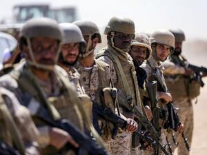 Saudi soldiers stand by in an airfield as a Saudi Air Force cargo plane lands at an airfield in Yemen's northeastern province of Marib on Jan. 26, 2018 (ABDULLAH AL-QADRY / AFP)