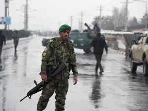 Afghan security personnel stand guard near the site of an attack near the Marshal Fahim Military Academy base in Kabul on Jan. 29, 2018 (WAKIL KOHSAR / AFP)