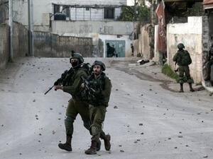 Israeli soldiers advance through the Palestinian village of Burqin in the northern occupied West Bank, during an army search operation on Feb. 3, 2018 (JAAFAR ASHTIYEH / AFP)