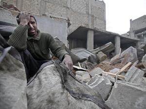 A Syrian man mourns over his destroyed home in the rebel-held besieged town of Arbin, in the eastern Ghouta region on the outskirts of the capital Damascus on Feb. 5, 2018, following airstrikes (ABDULMONAM EASSA / AFP)