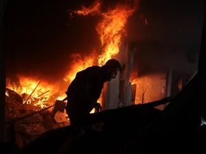 A Syrian man searches for people in a fire following regime air strikes on the rebel-held besieged town of Douma in the eastern Ghouta region, on the outskirts of the capital Damascus, on Feb. 7, 2018. 
(Hamza Al-Ajweh / AFP)
