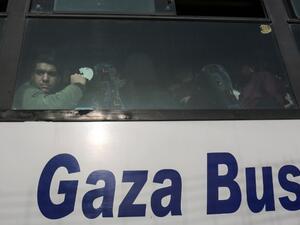A Palestinian looks out of the window of a bus as travelers arrive at the Rafah border crossing in the southern Gaza Strip to cross into Egypt, after it was opened by Egyptian authorities for humanitarian cases on Feb. 7, 2018.
(SAID KHATIB / AFP)