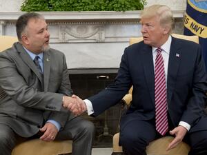 U.S. President Donald Trump shakes hands with Donald Bouvet (L), the father of a Trump presidential campaign volunteer who received a check for $10,000 from Trump with the money being used to treat Bouvet's bladder cancer, during a meeting in the Oval Office of the White House in Washington, DC, Feb. 9, 2018. 
(SAUL LOEB / AFP)