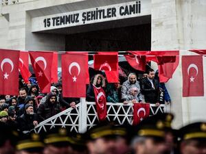 People stand by Turkish flags as they attend a funeral ceremony for Koray Karaca, a Turkish soldier who was killed in cross-border clashes with Kurdish People's Protection Units (YPG) forces in Afrin, Syria, in Istanbul on Feb. 11, 2018. On Jan. 20, Turkey launched a military operation against the Kurdish People's Protection Units (YPG) militia in the Afrin region, backing Syrian rebels with air strikes and ground troops.
(YASIN AKGUL / AFP)
