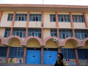 A child plays in front of a UNRWA-run school in Baqa'a camp, Jordan. (Khalil MAZRAAWI / AFP)