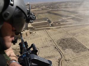 An Afghan soldier looks out from a helicopter over part of Paktika province. (AFP/Shah Marai)
