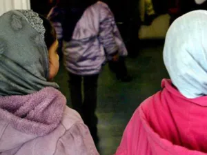 Investigation into online abuse targeting the head teacher of an East London where girls younger than the age of eight were banned from wearing the hijab (AFP)