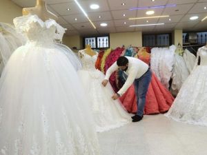 Man arranging dresses at a wedding dresses shop (AFP/File Photo)	 